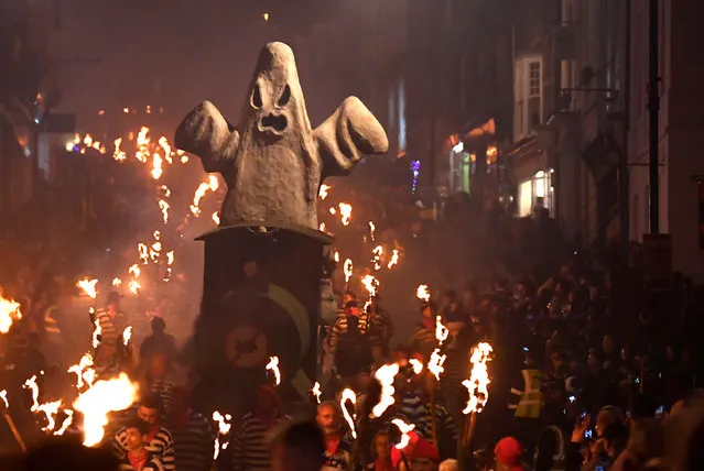 An effigy is pulled on a cart as participants parade through the town during the annual Bonfire Night festivities in Lewes, Britain on November 5, 2018. (Photo by Toby Melville/Reuters)