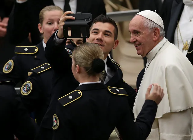 Pope Francis has his picture taken by an Argentinian policeman during his Wednesday general audience in Paul VI hall at the Vatican December 21, 2016. (Photo by Alessandro Bianchi/Reuters)