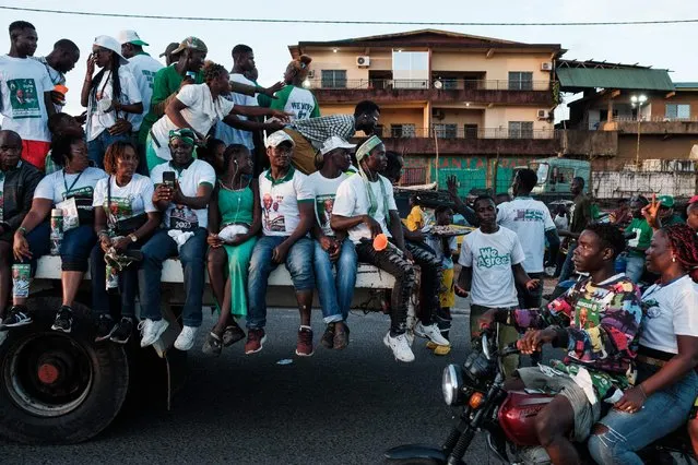 Supporters of the main opposition leader Joseph Boakai and his political party Unity Party (UP) take part in the procession on the back of a lorry during their final campaign rally in Monrovia on October 7, 2023. Liberians are scheduled to head to the polls for a general election on October 10, 2023. (Photo by Guy Peterson/AFP Photo)