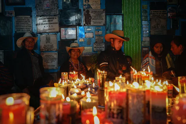 Guatemalan devotees of the folk San Simon, known by some as Maximon, celebrate his birthday in a temple dedicated to Saint Simon in San Andres Itzapa, Guatemala on October 28, 2023. Thousands of Guatemalan devotees visited the Saint Simon temple, the most beloved folk saint in the country, for his birthday, which coincides with the day of Saint Jude the Apostle. (Photo by David Toro/EPA/EFE)