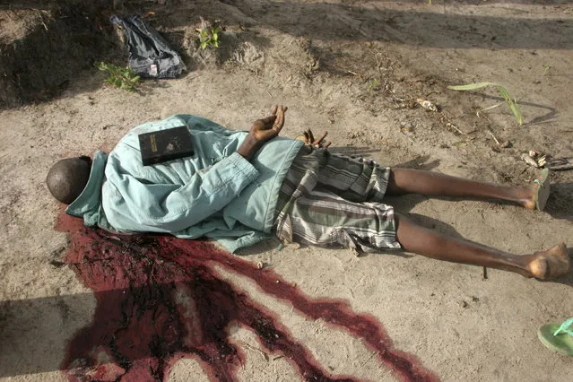 Al Shabaab's repeated raids, together with attacks on churches by home-grown Islamist groups, have strained the historically cordial relations between Kenya's Muslim and Christian communities. Here: a bible placed by gunmen is seen on the back of the slain body of a man after an attack in Hindi village, near Kenya's coastal town of Lamu, July 6, 2014. (Photo by Abdalla Barghash/Reuters)