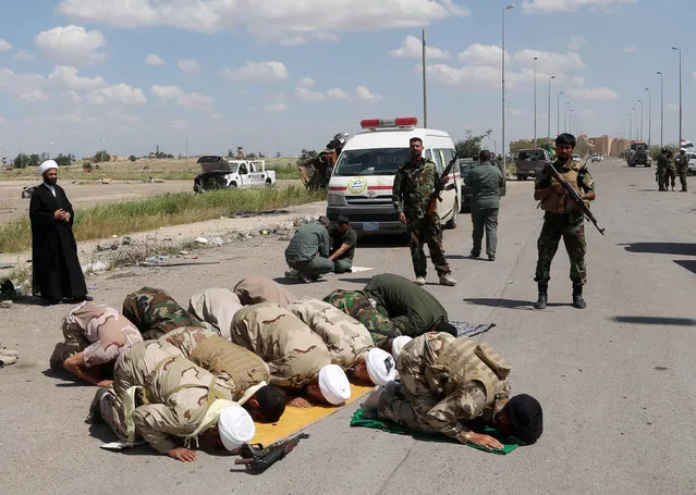 Shiite militiamen pray at one of Saddam Hussein's palaces in Tikrit, 80 miles (130 kilometers) north of Baghdad, Iraq, Thursday, April 2, 2015, a day after Iraqi security forces backed by Shiite militas took control of the city from Islamic State militants.(Photo by Khalid Mohammed/AP Photo)