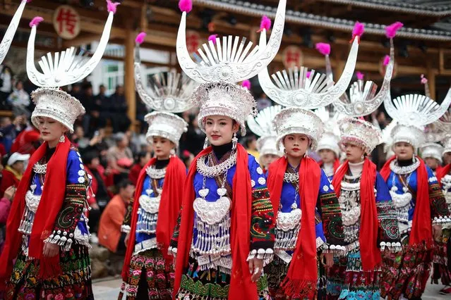 Women of the Miao ethnic minority, dressed in traditional costumes, take part in the celebration of the Guzang Festival in Leishan county, in China's southwestern Guizhou province on November 22, 2023. (Photo by AFP Photo/China Stringer Network)