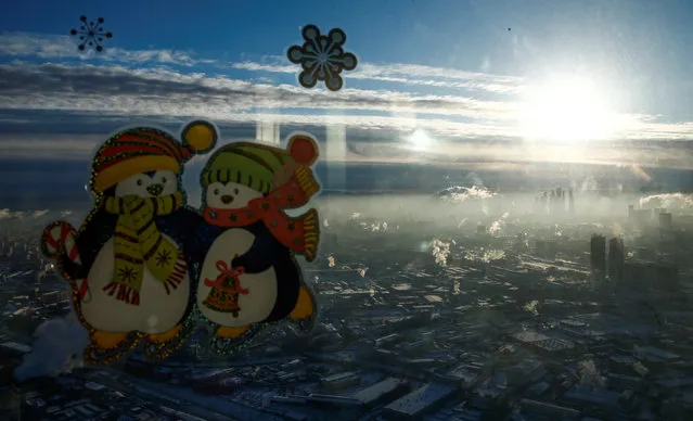 A sticker is pictured on the window glass of the viewpoint of Ostankino tower, with the surrounding cityscape in the background in Moscow, Russia January 8, 2017. (Photo by Maxim Shemetov/Reuters)