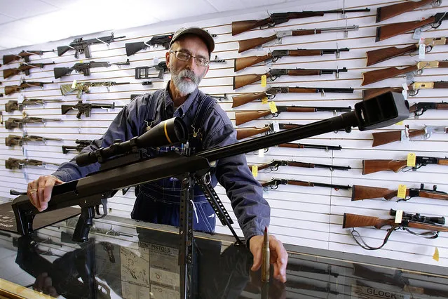 In this December 4, 2008, file photo, Capitol City Arms Supply owner Steve Swartz shows off a Barrett .50-caliber rifle in Springfield, Ill. The Tennessee Senate on Wednesday, February 24, 2016, gave final approval to a resolution designating the firearm as the state's official state rifle. (Photo by Seth Perlman/AP Photo)