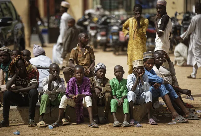 Young Muslim boys wait for traditional Friday prayers to begin at a mosque near to the Emir's palace a day prior to the start of the elections, in Kano, northern Nigeria, Friday, February 15, 2019. (Photo by Ben Curtis/AP Photo)