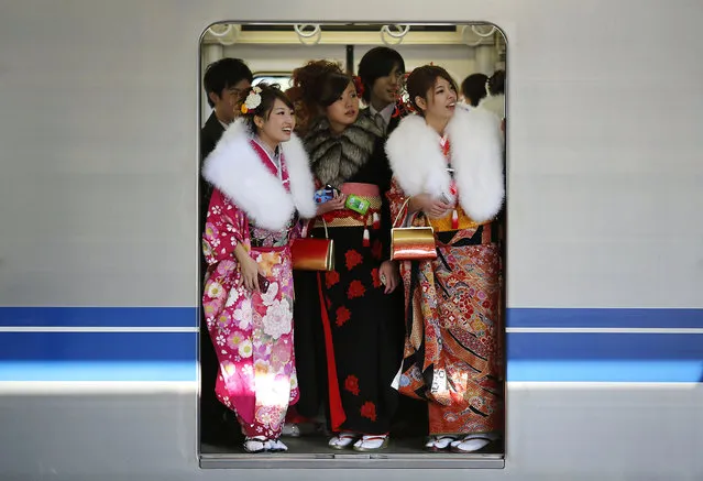 Japanese women in kimonos ride a train after a ceremony celebrating Coming of Age Day at an amusement park in Tokyo January 13, 2014. According to a government announcement, about 1,210,000 men and women who were born in 1993 reached coming of age this year and the number is 10,000 less people than last year. The figure is the smallest number since the government started counting in 1968. (Photo by Yuya Shino/Reuters)