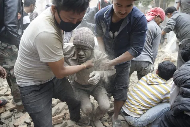 People free a man from the rubble of a destroyed building after an earthquake hit Nepal, in Kathmandu, Nepal, 25 April 2015. (Photo by Narendra Shrestha/EPA)