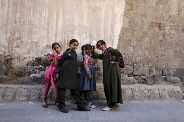 Girls pose for a photo in the old quarter of Yemen's capital Sanaa March 8, 2016. (Photo by Khaled Abdullah/Reuters)