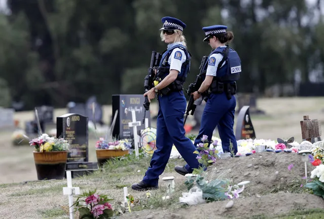 Armed police patrol a cemetery near Muslim graves in Christchurch, New Zealand, Monday, March 18, 2019. An immigrant-hating white nationalist is accused of killing dozens of people as they gathered for weekly prayers in Christchurch on March 15. (Photo by Mark Baker/AP Photo)
