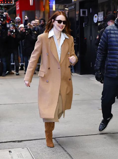 Emma Stone is pictured stepping out in Midtown in New York City on January 30, 2024. The 35 year old American actress wore a wool trench coat, white blouse, and thigh high brown boots. (Photo by The Image Direct)