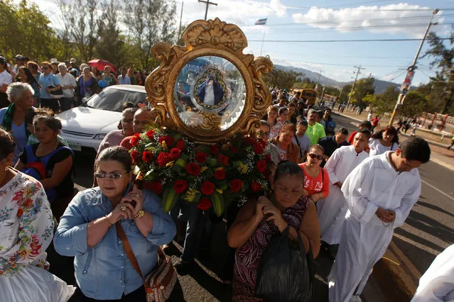 Catholics carry the statue of the Virgin of Suyapa, the patron saint of Honduras, during celebrations for what Hondurans believe to be the 270th anniversary of its discovery, in Tegucigalpa, Honduras February 2, 2017. (Photo by Jorge Cabrera/Reuters)
