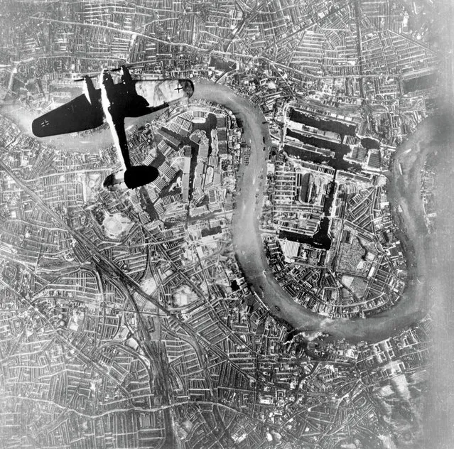 A Heinkel He111 bomber flies over central London on 7 September 1940 in this shot taken by the Luftwaffe, and found in a German archive of aerial photography seized by the Allies after the War. Visible directly below is one of the city's key targets – the huge industrial complex of the Royal Docks. 1940. (Photo by US National Archives)