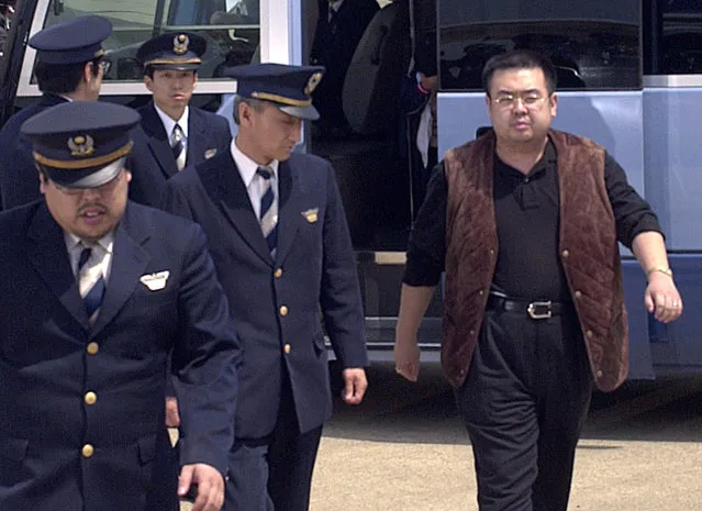 In this May 4, 2001, photo, a man believed to be Kim Jong Nam, right, the eldest son of then North Korean leader Kim Jong Il, walks out of a police van to board a plane to Beijing at Narita international airport in Narita, northeast of Tokyo. Malaysian officials say a North Korean man has died after suddenly becoming ill at Kuala Lumpur's airport. The district police chief said Tuesday February 14, 2017 he could not confirm South Korean media reports that the man was Kim Jong Nam, the older brother of North Korean leader Kim Jong Un.﻿﻿   (Photo by Kyodo News via AP Photo)