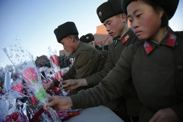 North Korean military soldiers gather at Munsu Hill to offer flowers in front of bronze statues of late leaders Kim Il Sung, left, and Kim Jong Il, right, as part of celebrations a day before the birthday anniversary, or “Day of the Shining Star”, of Kim Jong Il on Monday, February 15, 2016, in Pyongyang, North Korea. (Photo by Wong Maye-E/AP Photo)