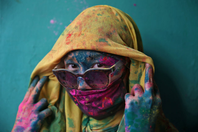 A woman poses for a photograph during Holi celebrations in the town of Barsana in the state of Uttar Pradesh, India, March 6, 2017. (Photo by Cathal McNaughton/Reuters)