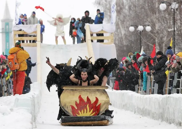 Participants ride down a slope during the “Sunnyfest” festival of unusual sledges in the town of Mamadysh in the Republic of Tatarstan, Russia on February 6, 2021. (Photo by Alexey Nasyrov/Reuters)