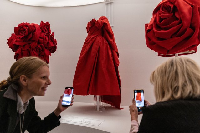 People take pictures of an ensemble of clothes during the press preview of the Costume Institute exhibit “Sleeping Beauties: Reawakening Fashion” at the Metropolitan Museum of Art in Manhattan in New York City, on May 6, 2024. (Photo by Jeenah Moon/Reuters)