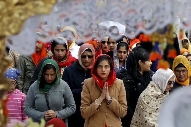Women from the Sikh community line up to pray during Khalsa Day, also known as Vaisakhi, in front of city hall in Toronto, Canada April 24, 2016. (Photo by Chris Helgren/Reuters)