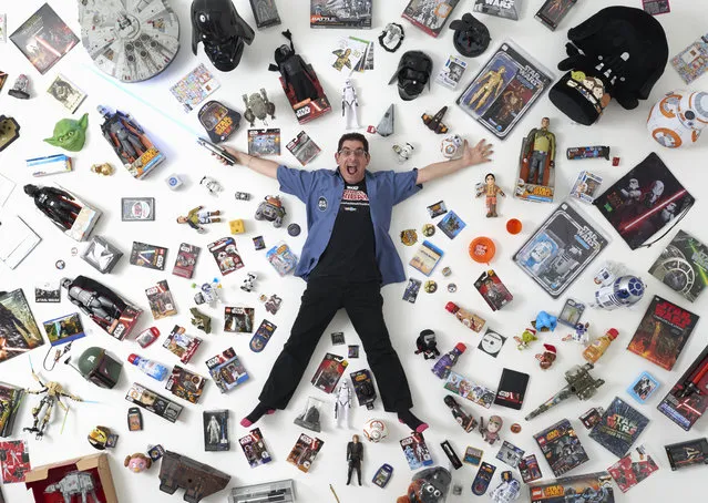 Star Wars collector James Burns, 44, poses for a photograph with some of his collection in London December 2, 2015. He said “I've met so many wonderful people, all over the world. It's a wonderful community of like-minded people with an interest in Star Wars. There's nothing else like it”. (Photo by Paul Hackett/Reuters)