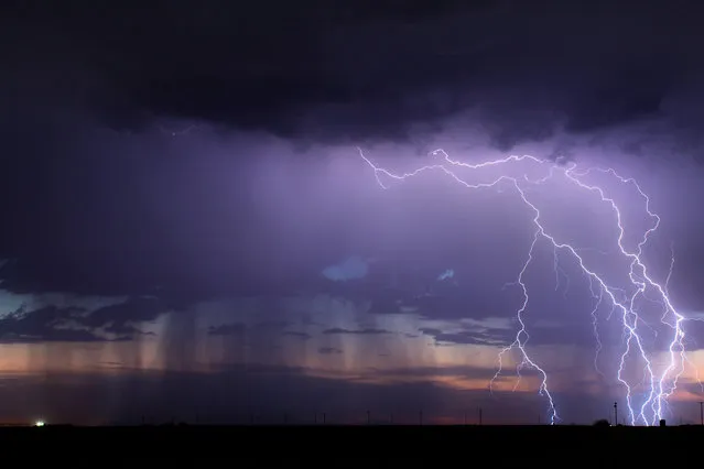 A storm sends down hundreds of bolts over 2 hours out near Buckeye, Arizona in August 2013. (Photo by Mike Olbinski/Barcroft Media)