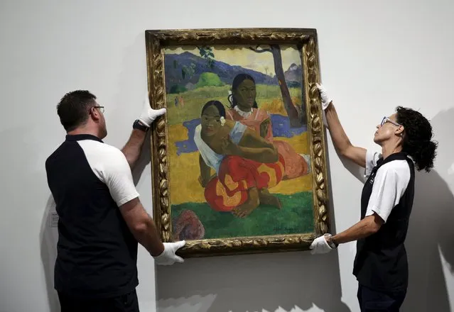 Museum workers hang Paul Gaugin's “Nafea faa ipoipo” (When will you marry) on a wall at the Reina Sofia museum in Madrid, Spain, July 3, 2015. The painting, believed to be the world's most expensive painting, is on show at Madrid's Reina Sofia among other paintings coming from the Basel museum, according to media and museum sources. (Photo by Andrea Comas/Reuters)