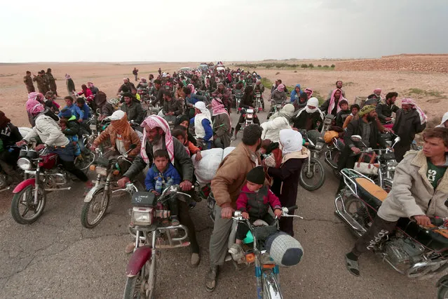 People fleeing from areas surrounding Euphrates River dam, east of Raqqa city, ride their motorcycles towards Syrian Democratic Forces (SDF) controlled areas, Syria March 30, 2017. (Photo by Rodi Said/Reuters)
