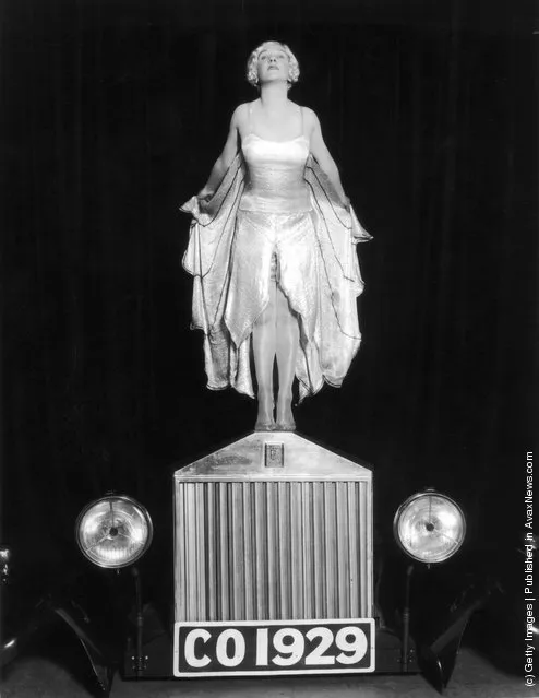 1929: Entertainer Elsa McFarlane stands on the bonnet of a Rolls Royce car, mimicking the Silver Lady figurine, in a production of 'The Co-Optimists', at the Vaudeville Theatre in London