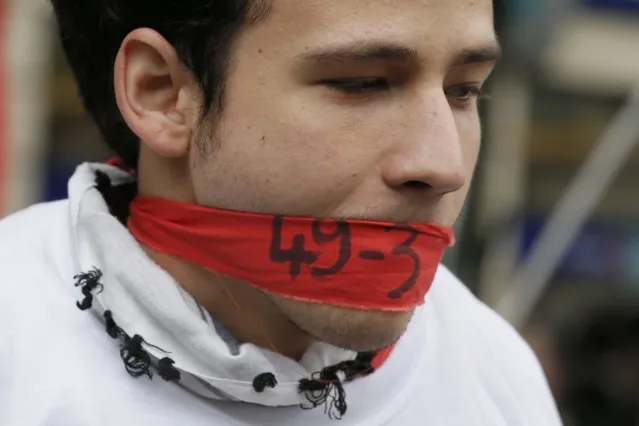 A gagged youth with the numbers, “49-3” attends a demonstration against the French labour law in Paris, France, May 12, 2016. France's government decided on Tuesday to bypass parliament and impose a relaxation of the country's protective labour laws by decree, using article 49.3 of the French constitution, pushing through a labour reform bill. (Photo by Gonzalo Fuentes/Reuters)