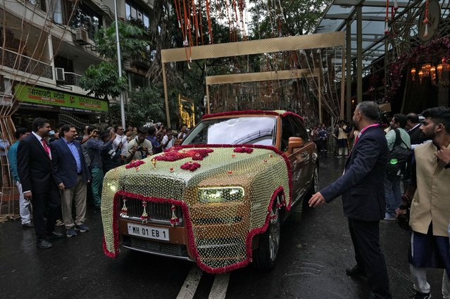 A decorated Rolls-Royce car carrying guests leaves Antilia, the house of Indian businessman Mukesh Ambani, on the day of Anant Ambani's wedding in Mumbai, India, on July 12, 2024. (Photo by Hemanshi Kamani/Reuters)