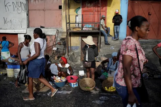 Vendors wait for customers in a street market of Petion Ville, that remains open despite weeks of protest, Port-au-Prince, Haiti on October 1, 2019. (Photo by Andres Martinez Casares/Reuters)