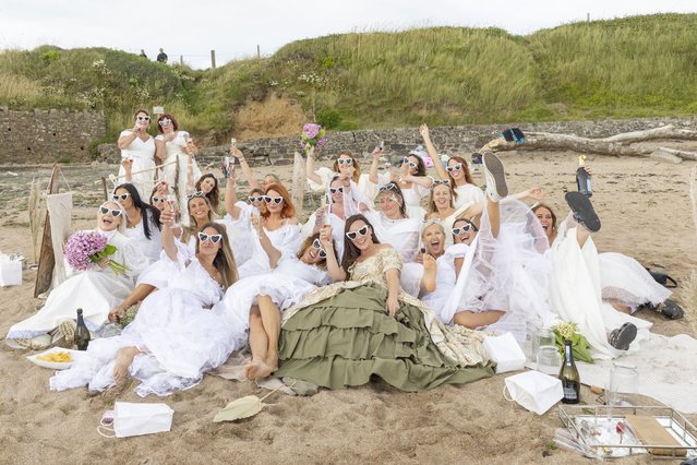 Everyone’s a bride at this hen party in Croyde Bay, North Devon, UK as 22 women hit the beach on July 28, 2024. (Photo by Becky Hutner/Splash News and Pictures)