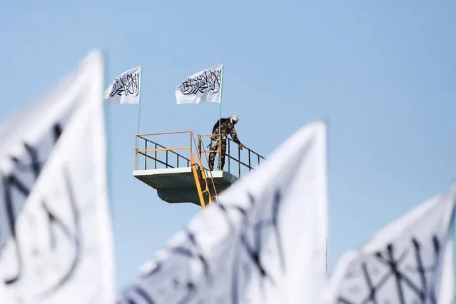 A Taliban fighter is seen at the Taliban flag-raising ceremony in Kabul, Afghanistan, March 31, 2022. (Photo by Ali Khara/Reuters)