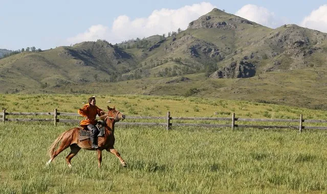 A Khakas equestrian rides a horse during the reconstruction of daily life and traditional holidays celebrated by indigenous population of the Republic of Khakassia during a demonstration for visitors at a museum preserve outside Kazanovka village, southwest of the city of Abakan, Russia, July 24, 2015. (Photo by Ilya Naymushin/Reuters)