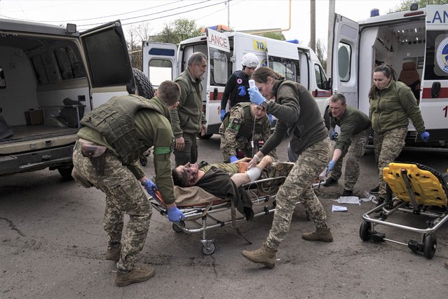 Ukrainian military medics move an injured Ukrainian serviceman to a hospital in Donetsk region, eastern Ukraine, Saturday, April 23, 2022. (Photo by Evgeniy Maloletka/AP Photo)