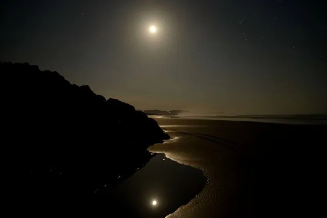 “Moonligth in paradise”. One day after the red moon eclipse. Quiet warm night at the beach reflected wirh the moon reflected on ponds with soft light inviting to meditate and enjoy the moment. Photo location: San Miguel Beach, Guanacaste, Costa Rica. (Photo and caption by Hernan Hernandez/National Geographic Photo Contest)