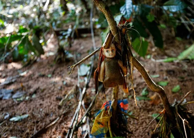 A child's doll is seen with debris where a body was recovered on the Mzinyathi River after heavy rains caused flooding near Durban, South Africa, April 19, 2022. (Photo by Rogan Ward/Reuters)