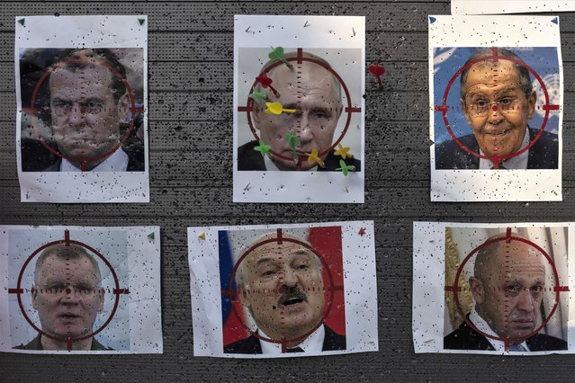 Darts are stuck on a paper target made with an image of Russian President Vladimir Putin at a popular beachside attraction in Odesa, Ukraine, Sunday, July 23, 2023. Ever since Ukrainian independence, Odesa saw itself differently than other major Ukrainian cities, because of its long, conflicted history with both Ukraine and Russia and an outlook that stretched far beyond the borders of both. (Photo by Jae C. Hong/AP Photo)