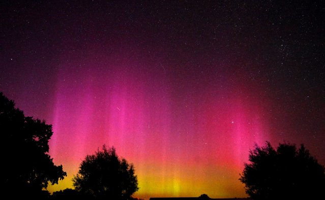 This long exposure picture shows the northern lights (aurora borealis) illuminating the sky above Guelpe by Havelaue in the Dark-sky preserve Westhavelland (Sternepark Westhavelland), eastern Germany, during the annual Perseids meteor shower early on August 13, 2024. (Photo by Ralf Hirschberger/AFP Photo)