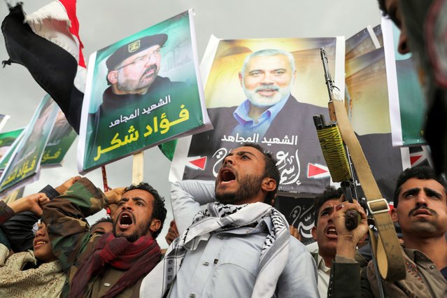 Protesters, mainly Houthi supporters, hold posters of Hezbollah senior commander Fuad Shukr, who was killed in an Israeli strike, and assassinated Hamas chief Ismail Haniyeh, at the rally to show solidarity with Palestinians in the Gaza Strip, in Sanaa, Yemen, on August 2, 2024. (Photo by Khaled Abdullah/Reuters)