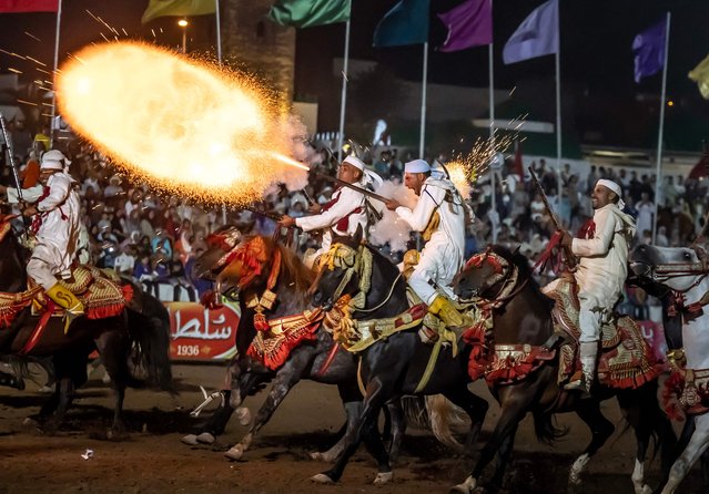 Moroccan horsemen fire their rifles during a performance to celebrate the annual Moussem festival in El Jadida on August 6, 2023. (Photo by Fadel Senna/AFP Photo)