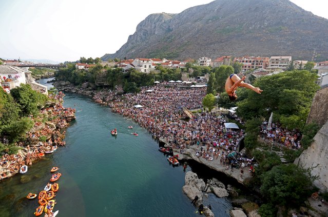 A competitor jumps from the Old Bridge during the Red Bull Cliff Diving Competition in Mostar, Bosnia and Herzegovina on August 15, 2015. (Photo by Dado Ruvic/Reuters)