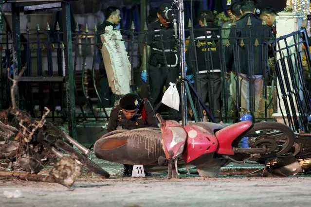 Experts investigate the remains of destroyed motorcycles at the Erawan shrine, the site of the blast in central Bangkok August 17, 2015. (Photo by Kerek Wongsa/Reuters)