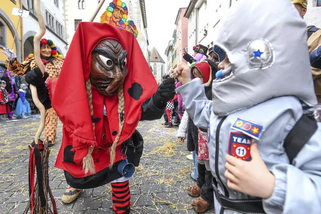 A group of fools dressed as witches attend a parade during the great fool's leap through the city centre of Konstanz, Germany, Sunday, February 23, 2020. (Photo by Felix Kaestle/dpa via AP Photo)