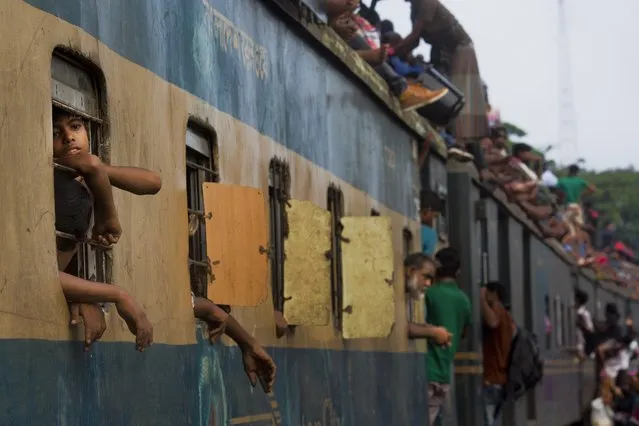 Bangladeshi Muslims travel on an overcrowded train as they head to their hometowns ahead of Eid al-Adha in Dhaka, Bangladesh, Friday, September 1, 2017. (Photo by Bernat Armangue/AP Photo)