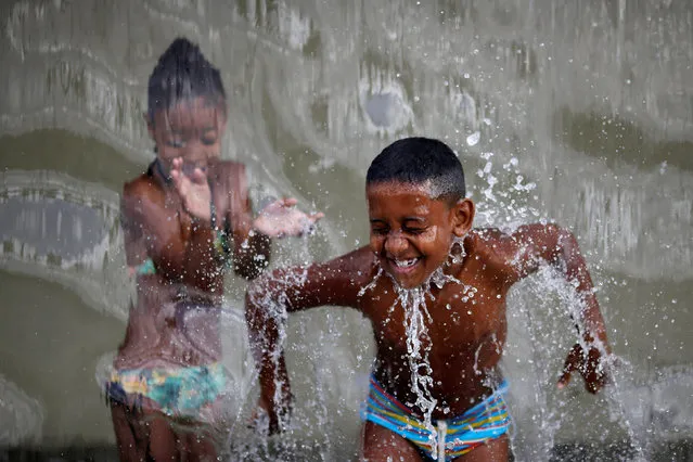 Children play with water inside the Madureira Park ahead of the Rio 2016 Olympic Games in Rio de Janeiro, Brazil, July 17, 2016. (Photo by Ueslei Marcelino/Reuters)