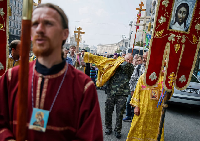 Faithfuls of Ukrainian Orthodox Church of the Moscow Patriarchate take part in a procession petitioning for peace marking the Christianisation of the country, which was known as Kievan Rus', by its grand prince, Vladimir I (Vladimir the Great) in 988AD, in Kiev, Ukraine July 27, 2016. (Photo by Gleb Garanich/Reuters)