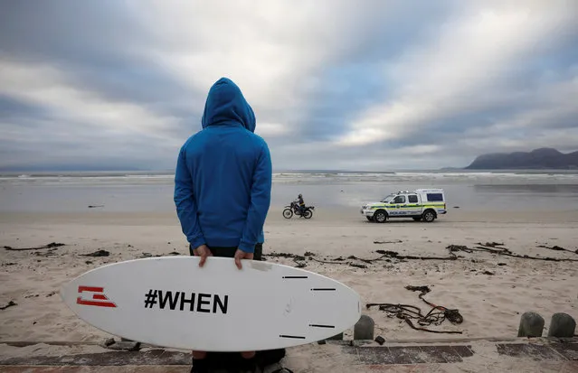 Police patrols as surfers and other ocean users protest against the nationwide lockdown regulations that allow exercise but not water activities, amid the coronavirus disease (COVID-19) outbreak, at Muizenberg beach in Cape Town, South Africa on May 5, 2020. (Photo by Mike Hutchings/Reuters)