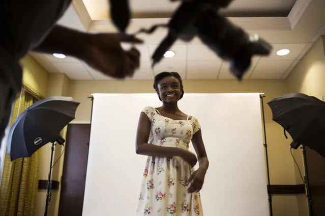 Asya Mercer, 12, of Woodbridge, Va., talks to the photographer about her shots during an indoor photo shoot at a modeling camp at the Courtyard Marriott Hotel in McLean, Va., on Tuesday, August 19th, 2015. (Photo by Brittany Greeson/The Washington Post)