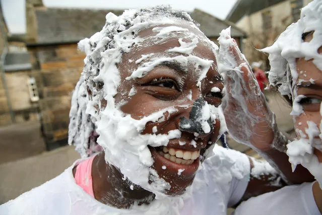 Students from St Andrews University are covered in foam as they take part in the traditional “Raisin Weekend” in the Lower College Lawn, at St Andrews in Scotland, Britain October 23, 2017. The weekend, which begins on Sunday, involves rituals for new students, culminating in a foam fight on Monday morning. (Photo by Russell Cheyne/Reuters)